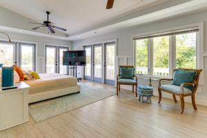 a bedroom with a bed and two chairs and a table at Walk to Wabasso Beach Home with Hot Tub and Bikes in Sebastian