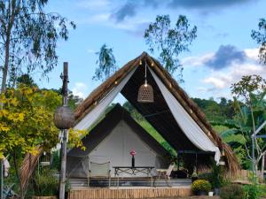a large white tent with a black roof at Nai Suan Phan Resort - ในสวนฝัน รีสอร์ท in Ban Thung Samoe