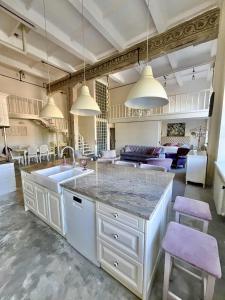 a kitchen with a sink and a living room at Kaunas Design Loft in Kaunas +8 photos