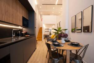 a kitchen and dining room with a table and chairs at LOFT Accommodative B in Valencia