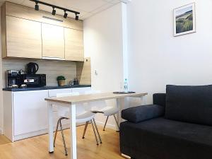 a living room with a table and a couch at Apartimento Hydral Sole in Wrocław