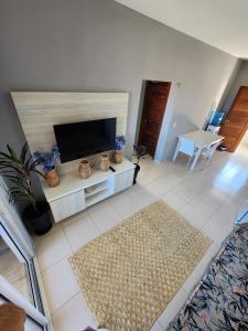 a living room with a television and a fireplace at O Rei Do Cumbuco - Cumbuco Residence in Caucaia