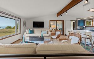a living room with a couch and a table at Scenic Shores, Your Front Row Seat to Lake Michigan Sunsets in Rothbury