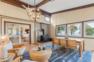 a living room with a table and a dining room at Scenic Shores, Your Front Row Seat to Lake Michigan Sunsets in Rothbury