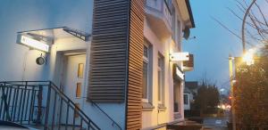 a building with a staircase on the side of it at Pensionen Akropolis in Rellingen