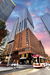 a tall building with a bus in front of it at Riu Plaza Toronto in Toronto