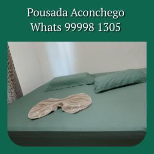 a bow tie sitting on top of a bed at Pousada Aconchego in Sidrolândia