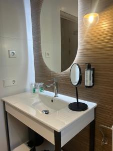 a bathroom with a sink and a mirror at Petit Garden Hotel by Flacalco in Cala Ratjada