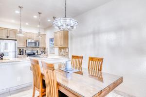 a kitchen with a wooden table and chairs at Wailea Grand Champions 87 in Wailea +20 photos