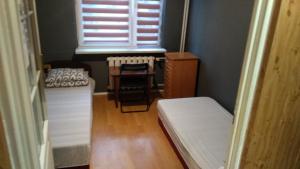 a small room with two beds and a window at FEIDUM quarters rooms in Trzebinia