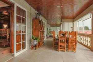 a dining room with wooden chairs and a table at Casona BRETEMA in Piñeiro