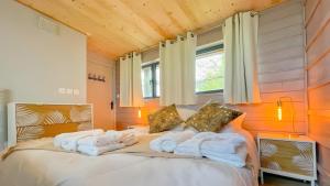 une chambre avec un lit avec des serviettes dessus dans l'établissement La villa Grand Ouest, à Plounéour-Trez 17 autres photos