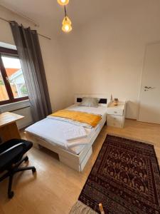 a bedroom with a bed and a desk and a chair at Apartment nahe Frankfurt am Main mit Parkplätzen PKW oder VAN in Rödermark
