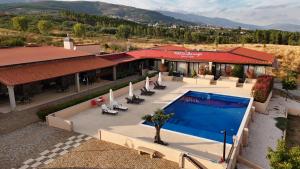 an overhead view of a house with a swimming pool at Tranca da Barriga - Casa do Vinho by Quinta De São Tiago in Covilhã