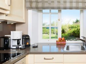 a kitchen with a sink and a window at Prahl-Hues-1 in Kampen