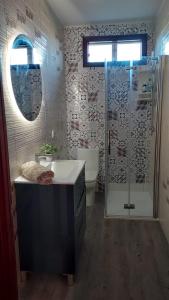 a bathroom with a shower and a sink and a toilet at Casa a 2 minutos andando a la playa de Panxón in Nigrán +27 photos