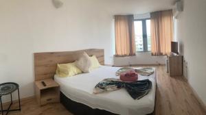 a bedroom with a bed with white sheets and pillows at Casa De Zambini in Plovdiv