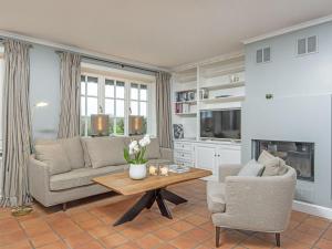 a living room with a couch and chairs and a table at Prahl-Hues-4 in Kampen
