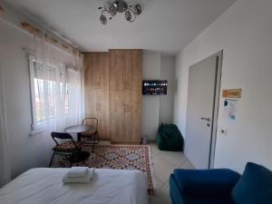 a bedroom with a bed and a table and a door at Isabel Rooms in Tirana