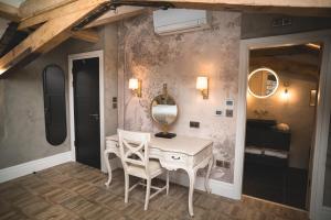 a dressing room with a table and a mirror at Old School House, Halkyn in Halkyn