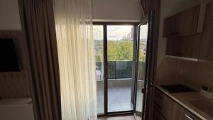 a kitchen with a sliding glass door to a balcony at Мотел Ханай 