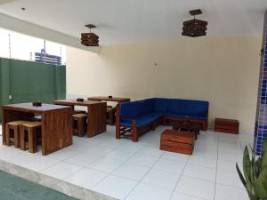 a living room with a blue couch and tables at Pousada e Hostel F C in Natal +24 photos