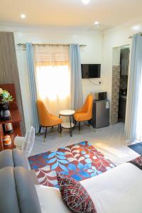 a bedroom with a bed and a table and chairs at Luxury Gem in Nsambya 1km from American Embassy in Kampala