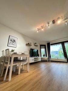 a dining room with a white table and chairs at Louis Haus in Lahnstein