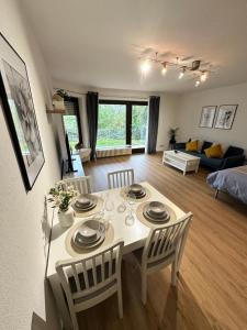 a kitchen and living room with a table and chairs at Louis Haus in Lahnstein