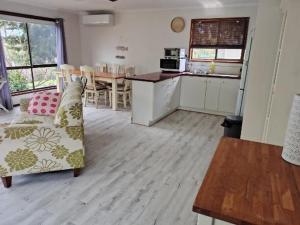 GrantvilleGrantville Stay Comfy Home, Near Beaches and Phillip Island的配有沙发和桌子的厨房和客厅