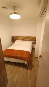 a bedroom with a bed with a wooden floor at Casa Los Naranjos in Marbella