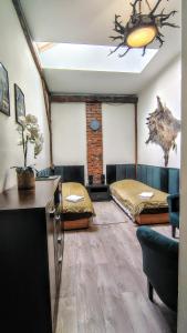a bedroom with two beds and a living room at Midas Strzyżów in Strzyżów +25 photos