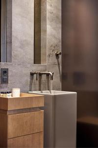 a bathroom with a sink and a toilet at Athens 1890 Hotel & Spa in Athens