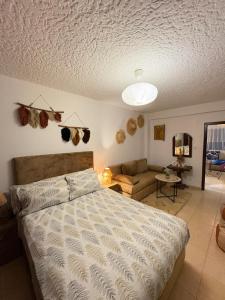 a bedroom with a bed and a couch at Apartment in Martil in Martil +10 photos