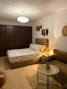 a living room with a bed and a coffee table at Apartment in Martil in Martil