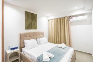 a small bedroom with a bed and a window at Luxury Villa with Heated Pool & Private cinema in Marrakesh +75 photos