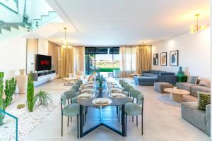 a large living room with a long table and chairs at Luxury Villa with Heated Pool & Private cinema in Marrakesh