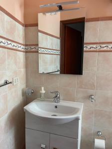 a bathroom with a sink and a mirror at Casa vacanze di Angelo in Isnello
