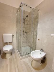 a bathroom with a shower and a toilet and a sink at Nido Flegreo in Pozzuoli +7 photos