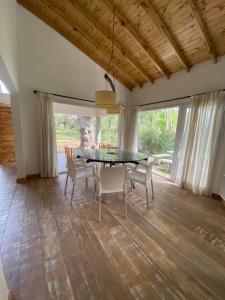 a dining room with a glass table and chairs at Casa en Costa Del Este in Costa del Este