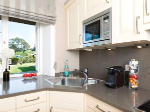 a kitchen with a sink and a microwave at Prahl-Hues-5 in Kampen