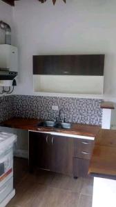a kitchen with a sink and a counter top at Casa Valle Verde in Sierra de los Padres