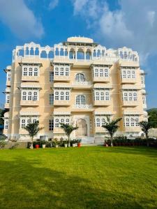 a large building with a lawn in front of it at Aryavarta A Boutique Abode in Nāi
