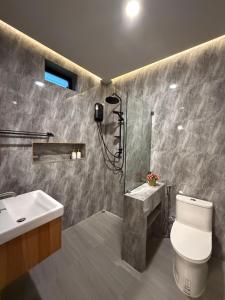 a bathroom with a shower and a toilet and a sink at The Cushty Days Lanta in Ko Lanta Yai +51 photos