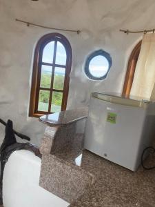 a room with a table and a tv on the floor at La Fortaleza De Haro in Puerto Ayora