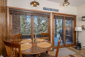 a dining room with a table and chairs and a large window at Snowflake at Skycrest in Big Sky