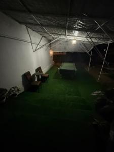 a dark room with a ping pong table and chairs at Casa Matei Costinești in Costinesti +18 photos