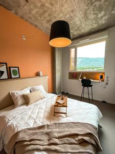 Ένα ή περισσότερα κρεβάτια σε δωμάτιο στο ECLA Genève Archamps