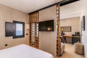 a bedroom with a bed and a desk in a room at 180 Suites in Imerovigli