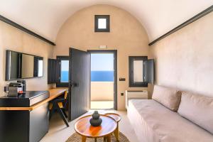 a living room with a couch and a table at 180 Suites in Imerovigli